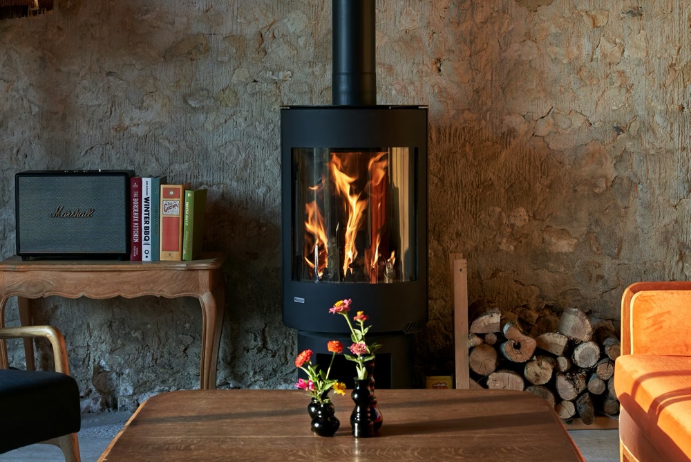 Living room of a Perche country house with a lit wood stove